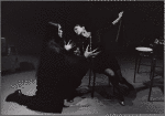 Nosferatu kneeling before woman on chair in a scene from Nosferatu  : A Symphony of Darkness