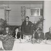 Carlton Moss (standing) addressing armed forces servicemen and women at annual Thanksgiving Dinner