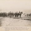 Construction of the Great Northern from Minot N.D. to Great Falls, Mont. about 1887. In the buckboard, Mr. Cox, paymaster and John Grant, contractor. In the Foreground, J.H. Benson. Standing on the track, John Moriarty, track inspector.