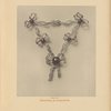 Diamond plastron with emeralds.