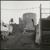 Contact sheet of pre-production location shooting with stand-ins.  Industrial asphalt ramp: young man in white running across it with another young man in dark clothes leaping off wall behind him to follow