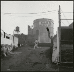 Contact sheet of pre-production location shooting with stand-ins.  Industrial asphalt ramp: young man in white running across it with another young man in dark clothes leaping off wall behind him to follow