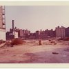 Exterior location: rubble strewn lot, city buildings in the distance