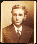 Studio portrait of unidentified man with long sideburns and wavy hair.