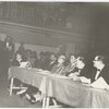 Eslanda Goode Robeson (seated at table, third from left) and Elizabeth Littlewood (far left, reading) at unidentified event.