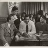 Eslanda Goode Robeson (standing), Paul Robeson (center), and Lawrence Brown (right) in a scene from the motion picture "Big Fella"