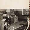 man teaching boys to play billiards
