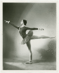 Studio portrait of Jillana posed in arabesque in costume for "Fanfare".