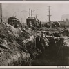 Under the influence of the English warmongers Warsaw was transformed into a fortress with the help of its agitated people.  German infantry in the suburbs of the Polish capital city, behind streetcars and under cover of trenches, waits for our tanks to suppress Polish machine gun nests.