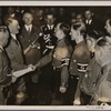 In the afternoon of the national holiday the Fuhrer received the Honor Delegation of German workers in the Mosaic Hall of the new Reichs Chancellery.  The Fuhrer greets the victors in the Reichs Trades Contest.  To the left of the Fuhrer is Reichs Leader Dr. Ley.