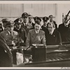 [The high point of the International Automobile and Motorcycle show in Berlin was the inspection of the KdF-Car by the Fuhrer.  At the Fuhrer's left is Dr. Ley, while Dr. Porsche, technical designer of the Volkswagen, is to his right.]