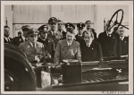 [The high point of the International Automobile and Motorcycle show in Berlin was the inspection of the KdF-Car by the Fuhrer.  At the Fuhrer's left is Dr. Ley, while Dr. Porsche, technical designer of the Volkswagen, is to his right.]