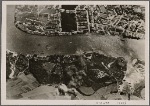 [...German bombs fall on strategic installations.  What show up in this picture as massive structures and huge complexes were, 48 hours later, an unbroken sea of rubble and flames.  London lived through what a neutral corrspondent called "apocalyptic nights".]