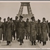 [The Fuhrer inspects Paris, which has quickly returned to normal life under German occupation troops.  At the Fuhrer's side are professors Giesler, Speer and Breker.  In the background is the Eiffel Tower.]