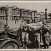 Life in France has returned to its normal routine under the German occupation, and the occupation troops helped to make it so.  Our picture shows German soldiers studying a newspaper from home on the "Place de la Concorde" in Paris.