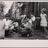 Children playing cards in front yard in slum area near Union Station. Section inhabited by both whites and Negroes. Washington, D.C.