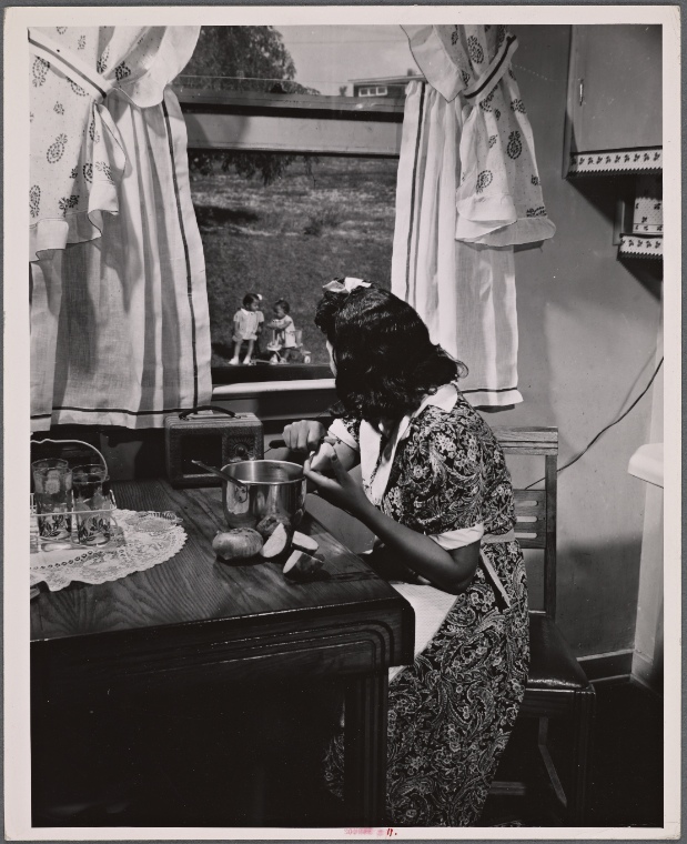 Farm Security Adminstration photograph of an Anacostia, D.C. mother watching her children out the window as she prepares a meal. Gordon Parks, 1942, image ID 3969615