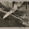Bomb after bomb hits home; in retaliation the German Air Force attacked deeper and deeper into the economic structure of the capital of the British Empire.  This shot from a German plane shows a cargo ship on fire in the lower Thames.