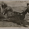 The Luftwaffe's actions against England continue without pause.  Again and again military installations in London and other English cities are the target of German bombs.  Our picture shows a bomb being moved to a bomber