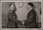 In his headquarters, the Führer personally awarded Colonel-General Rommel, commander of the German Afrika Korps, the Knight's Cross of the Iron Cross with Oak Leaves and Swords, making him only the sixth officer to receive it.