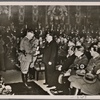 On May 2nd numerous National Socialist model enterprises were recognized by Dr. Ley at a festive meeting of the Reich Labor Board in the Mosaic Hall of the New Reich Chancellery.  By order of the Fuhrer Prof. Porsche, Prof. Heinkel and Reich Economics Minister Funk were named Pioneers of Labor.  Dr. Ley congratulates Prof. Heinkel.