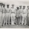 Tuskegee officers posing with their base commander Noel F. Parrish (4th from left) and unidentified man
