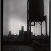 [Water tower; view of Hotel Paris (West End Ave & 97th St.) in distance: Manhattan]