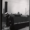 Tenement House Dept inspector on rooftop: Manhattan