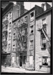 Tenement row with vacant tenement: Manhattan