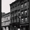 [Wooden row houses and storefronts; Home of Satisfaction Cleaning: 33 [street unknown], Manhattan]