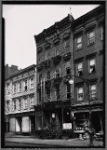 Wooden row houses and storefronts; Home of Satisfaction Cleaning: 33 [street unknown], Manhattan]