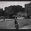Demoliton site, men outside shed: Manhattan