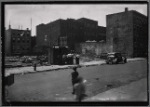 Demoliton site, men outside shed: Manhattan