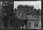 Rear of tenements, people sitting on fire escape: Manhattan