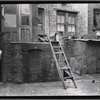 Rear of tenements with young boy: Manhattan