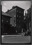 Inspector on street outside buildings