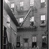 Tenement rear with girl posed in window