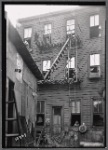 Tenement rear with girl posed in window
