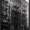 Street view with storefronts and tenements: Manhattan