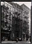 Street view with storefronts and tenements: Manhattan