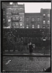 School boy in front of tenements and El