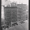 Tenements and storefronts with Christmas lights, from Elevated line: 1st Ave. - E. 12th St., Manhattan