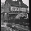 Abandoned wood frame house, with view of rear fire escape: Staten Island?