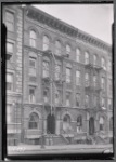 Tenement row; barber in first floor apartment