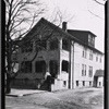 Stucco residence with porch: Bronx?