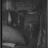 Windowless room interior with adult and three children