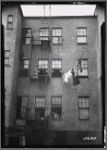 Tenement rear view with family posed in window