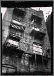 Tenement fire escapes blocked by planters and buckets: Bronx?