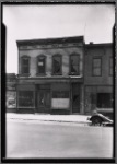 Wooden row house with vacant storefront