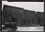 Vacant wooden houses; dirt sidewalk: Brooklyn?